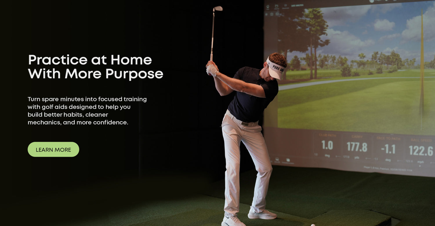 Coach Adam practicing indoors with golf training aids in a home simulator setup