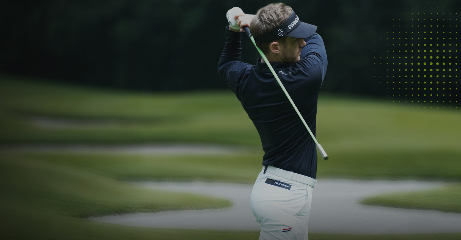 Coach Adam in action on a golf course with a blurred background