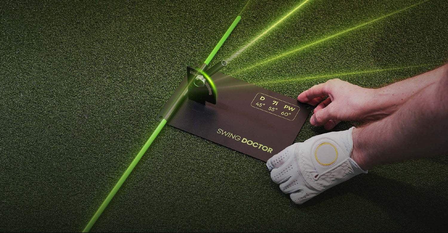 Golf swing analysis device on a green mat with a hand holding a golf glove.